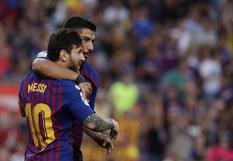 Lionel Messi and Luis Suarez both scored twice as La Liga giants Barcelona defeat Huesca 8-2