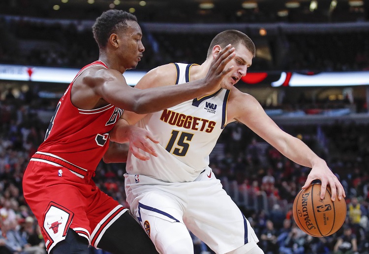 Nikola Jokic is defended by Wendell Carter Jr. during Denver Nuggets' NBA game vs Chicago Bulls