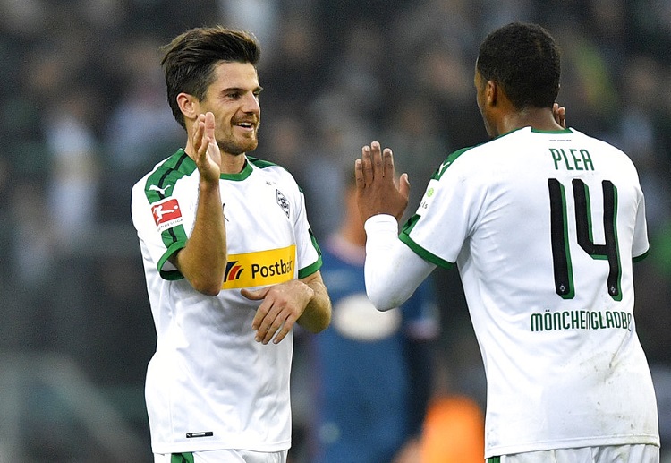 Moenchengladbach's Jonas Hofmann celebrates with Moenchengladbach's Alassane Plea in a Bundesliga game